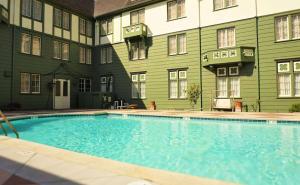 a large swimming pool in front of a building at Eureka Inn, Trademark Collection by Wyndham in Eureka