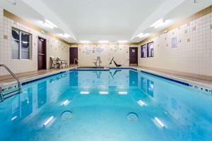 a swimming pool with blue water in a building at La Quinta by Wyndham Denver Gateway Park in Denver