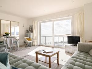 a living room with a couch and a large window at Sea Point in Exmouth