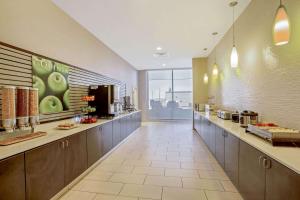 a large kitchen with a long line of counters at La Quinta by Wyndham Cedar City in Cedar City