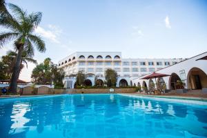a swimming pool in front of a building at Sirikwa Hotel in Eldoret