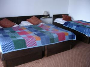 two beds sitting next to each other in a room at Tiffany Pension Bled in Bled