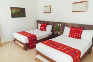 A bed or beds in a room at Hotel Casa Lakyum