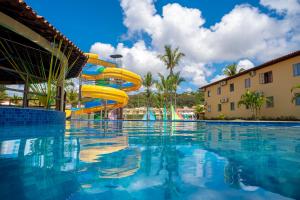 a swimming pool with a water slide in a resort at Portobello Park Hotel in Porto Seguro
