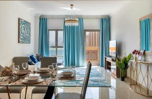 a dining room and living room with a table and chairs at GLOBALSTAY at Sarai Apartments Beachfront Paradise with Pool and Gym in Dubai