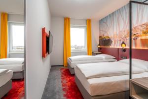 Ένα ή περισσότερα κρεβάτια σε δωμάτιο στο Campanile Duisburg City