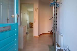 a room with a blue dresser and a hallway at Fréjus 116 - Kustpark Village Scaldia in Hoofdplaat +42 photos