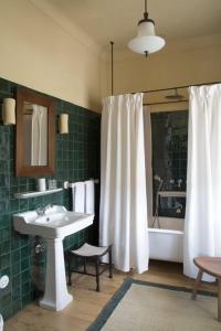 a bathroom with a sink and a tub and a shower at Quinta da Côrte in Valença do Douro