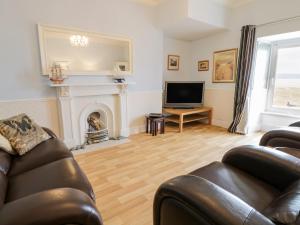 a living room with a couch and a fireplace at Abermaw Views in Barmouth