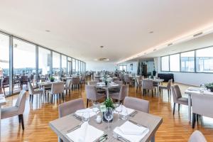 a large dining room with tables and chairs at Algarve Race Resort - Apartments in Portimão