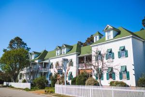 a large white house with a green roof at Roanoke Island Inn in Manteo