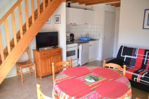 une cuisine et une salle à manger avec une table et une salle à manger dans l'établissement Village d'Armor, maison à Erdeven, à Erdeven