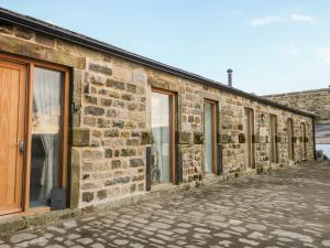 a row of windows on a brick building at Snave Cottage in Skipton