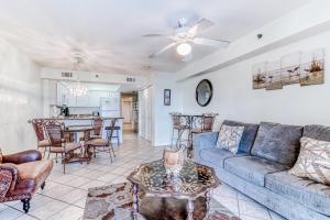 a living room with a couch and a table at Four Winds in Orange Beach
