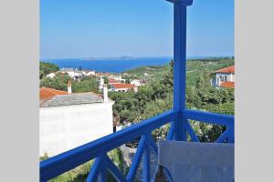 a view from a room with a blue window at ELECTRA TRADITIONAL HOUSE in Alonnisos