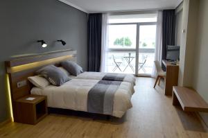 Tempat tidur dalam kamar di Hotel Alda Sada Marina