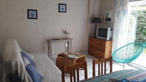 1 dormitorio con 1 cama, mesa y sillas en Ty Kreisker en Carnac
