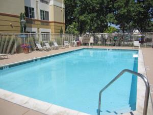 a pool with a pool table and chairs in it at Extended Stay America Premier Suites - San Jose - Airport in San Jose