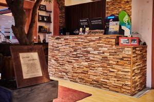 a counter in a restaurant with a brick wall at Strandhotel Weißer Berg in Neustadt am Rübenberge