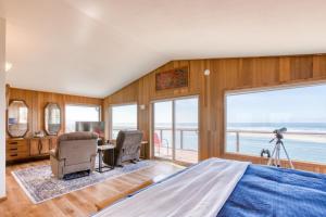 a bedroom with a bed and a view of the ocean at Windsong Cove in Netarts