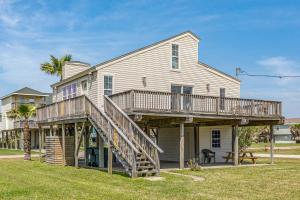 a large house with a deck on the side of it at Sunset Palms in Galveston