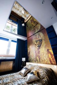 a bedroom with a large painting on the wall at Apartament Angel in Gdynia