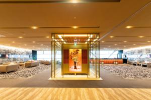 a large room with a lobby with couches at Sakishima Cosmo Tower Hotel in Osaka