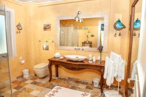 a bathroom with a sink and a toilet and a mirror at Swan Lake Hotel - Adult Only in Selimiye +121 photos