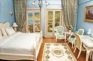 a bedroom with a bed and a table and chairs at Swan Lake Hotel - Adult Only in Selimiye