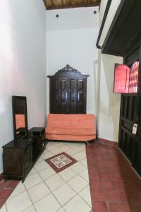 a living room with a chair and a cabinet at Hotel Casa del Consulado in Granada