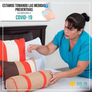 a woman wrapping a persons leg on a bed at R INN de TJ in Tijuana