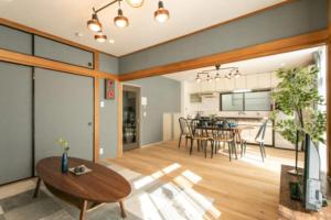 a living room with a table and a dining room at Secret House - 2 min to FuSe station - in Osaka