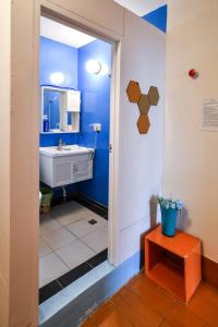 a bathroom with a white sink and a blue wall at 東石愛琴海藝宿文旅 合法民宿272 in Ting-liao