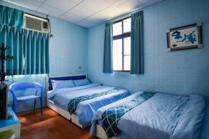 Postel nebo postele na pokoji v ubytování 東石愛琴海藝宿文旅 合法民宿272