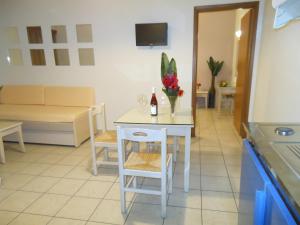 a kitchen with a table with a bottle of wine at Jechrina in Kato Daratso