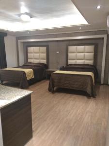 Postel nebo postele na pokoji v ubytování Hotel Jiménez Plaza