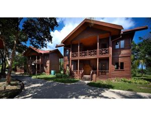 a large wooden house with a balcony on a street at Redang Island Resort in Redang Island