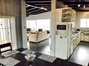 a kitchen and living room with a white refrigerator at Rosarito Beach House-- Spacious, Central, Beach View, & Sleeps 14 in Rosarito
