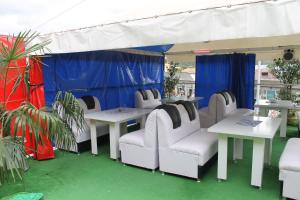 a group of white chairs and tables under a tent at Golden House in Batumi