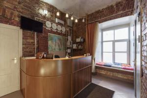 a lobby with a reception desk and a window at Meridian Hotel in Saint Petersburg