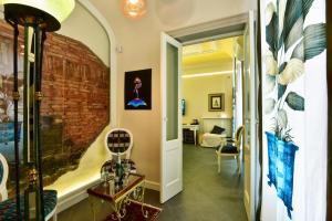 a hallway with a brick wall and a room at ANFITEATRO LE SUITES in Catania
