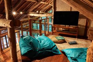 a living room with a tv and a couch at Bawah Reserve in Mampo