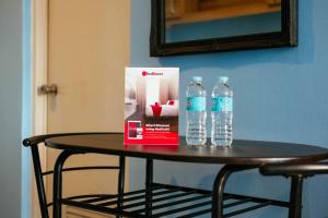 a table with a box and two bottles of water at RedDoorz @ Poblacion Sur Sigma in Sigma