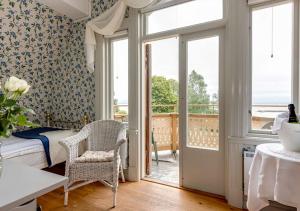 a bedroom with a bed and a window and a balcony at Hotel Bellevue in Hjo