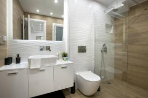 La salle de bains est pourvue d'une douche et de toilettes blanches. dans l'établissement (B) Koukaki, A modern, newly refurbished Studio 4ppl, à Athènes
