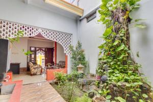 a living room with a wall of plants at OYO 3074 Orange Inn in Madiun