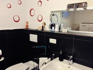 a bathroom with a sink and a mirror at Fernblick in Zweibrücken +32 photos
