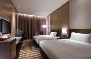 Postel nebo postele na pokoji v ubytování City Suites - Kaohsiung Chenai