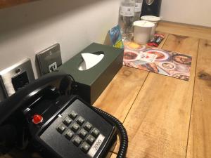 a phone with an apple mouse on top of a table at Hotel PaPa Whale in Taipei