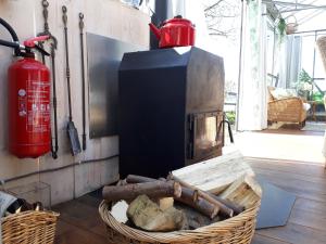 een brandkraan en een mand hout en een brandkraan bij Vrijstaande accommodatie Glamping de Kas InN in Hank